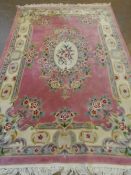 A WASHED CHINESE TRENTSIN ROSE COLOURED CARPET, APPROX. 274 X 183 CM