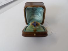 A LADY`S 18 CT YELLOW GOLD TESTED RENAISSANCE STYLE RING SET WITH BLUE STONES IN THE FORM OF A CROSS