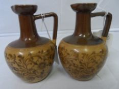 TWO DOULTON LAMBETH WARE TWO TONE LONG NECKED OIL / VINEGAR JUGS WITH IMPRESSED MARK TO BASE