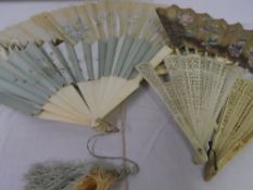 A MISC COLLECTION OF IVORY FANS SOME CARVED AND OTHERS PLAIN. CIRCA 18TH AND 19TH CENTURY. ONE OF