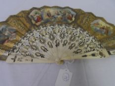 A CIRCA 19TH CENTURY EUROPEAN DOUBLE SIDED IVORY FAN. THE MOUNT HAVING THREE LITHOGRAPH VIGNETTES