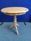 AN OVAL PINE OCCASIONAL TABLE ON TRIPOD BASE WITH TURNED COLUMN SUPPORT WITH SINGLE PULL THROUGH