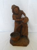 A BLACK FOREST  PEARS ADVERTISING FIGURE OF A BOY HAVING HIS EARS WASHED BY AN ELDERLY LADY,