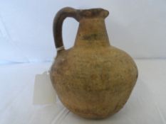 AN ANTIQUE, POSSIBLY ROMAN, TERRACOTTA JUG, APPROX. 14 CM