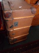 A FLAXITE WOOD AND METAL BANDED STEAMER TRUNK WITH CARRYING HANDLES TO EACH END