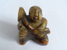 A CHINESE HARD STONE FIGURE OF A CROUCHING FIGURE OF MAN TOGETHER WITH A CARVED VESSEL DEPICTING A