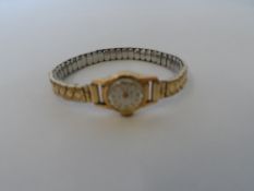 A LADY`S 18 K 750 HALLMARKED MUDU WRISTWATCH ON ELASTICATED BRACELET