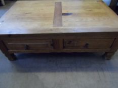 A RECLAIMED PINE COFFEE TABLE HAVING TWO DRAWERS TO EACH SIDE ON SQUARE SHAPED FEET, APPROX. 120 X