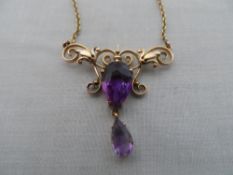 A 9 CT GOLD AND AMETHYST DROP PENDANT ON GOLD CHAIN. THE BUTTERFLY STYLE PENDANT SET WITH TWO TEAR