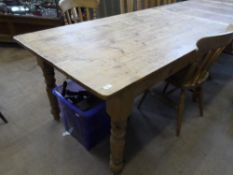 A PINE KITCHEN TABLE ON TURNED LEGS, APPROX. 90 X 151 X 77 CM TOGETHER WITH TWO PINE KITCHEN CHAIRS