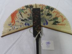 A CIRCA 19TH CENTURY JAPANESE DECORATED LACQUER AND PAPER FAN. THE TWIN DOUBLE, HAND PAINTED