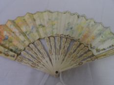 A HAND PAINTED IVORY AND PAPER EDWARDIAN FAN SIGNED H. AUBRY. THE HAND PAINTED MOUNT DEPICTING