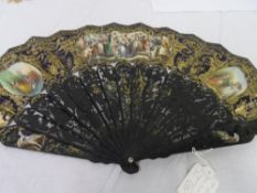 A 19TH CENTURY BLACK PAINTED DOUBLE SIDED IVORY / BONE CONTINENTAL LITHOGRAPH FAN. THE MOUNTS