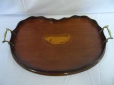 A VICTORIAN INLAID MAHOGANY SHERATON STYLE KIDNEY SHAPED TEA TRAY HAVING BRASS HANDLES AND GALLERY