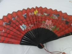A CIRCA 1890 DOUBLE SIDED JAPANESE HAND PAINTED LACQUER FAN. THE RED COLOURED MOUNT HAVING BIRDS AND