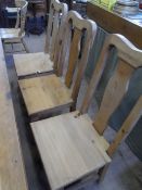 A SET OF SIX PINE DINING CHAIRS ON SHAPED FRONT LEGS