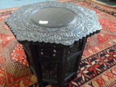 AN ANTIQUE EBONISED MIDDLE EASTERN CARVED OCTAGONAL COFFEE TABLE HAVING CARVED CAMEL AND FLOWERS