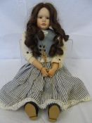 A BRUNETTE PORCELAIN DOLL `MARTHE` BY ELIN LINDTNER DATED 1994, WEARING A STRIPED COTTON SKIRT AND A