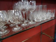 A COLLECTION OF CUT GLASS COMPRISING SIX BRANDY GLASSES, SIX WINE GLASSES, SIX TALL TUMBLERS AND SIX
