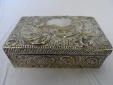 A SOLID SILVER CEDAR LINED CIGARETTE BOX DEPICTING FLOWERS.