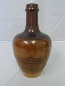 A DOULTON LAMBETH WARE TWO TONE BROWN POTTERY WHISKY JUG DEPICTING THE SENATE HOUSE, APPROX. 20 CM