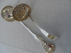 TWO SOLID SILVER SPOONS INCLUDING BIRMINGHAM HALLMARKED SUGAR SIFTER DEPICTING THISTLES TO BOWL