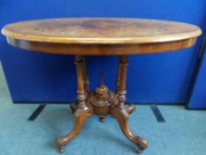 A VICTORIAN WALNUT VENEERED INLAID SUPPER TABLE  WITH FOUR COLUMN SUPPORTS WITH CARVED SCROLL FEET