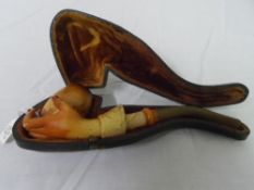 AN ANTIQUE AMBER AND MEERSCHAUM PIPE IN THE FORM OF A GAUNTLETTED HAND IN THE ORIGINAL BOX,