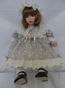 AN ALBERON PORCELAIN DOLL WITH FIXED BLUE EYES, THE DOLL HAS PORCELAIN LOWER ARMS AND LEGS,