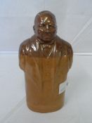 A DOULTON LAMBETH WARE STONEWARE SPIRIT FLASK IN THE FORM OF A 3/4 LENGTH POLITICIAN HAVING TWO TONE