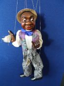 A MARIONETTE OF A BLACK PERFORMER BY FELLINGER  GESCHENKE - THE CHARACTER BEING DRESSED IN STRIPED