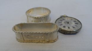 TWO LONDON HALLMARKED NAPKIN RINGS, MM R E C T TOGETHER WITH A FINE SILVER STAMPED WATCH CASE  (