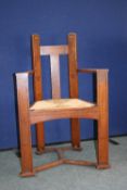 TWO RENE MACKINTOSH STYLE OAK RUSH SEATED ELBOW CHAIRS IN THE ARTS AND CRAFTS STYLE  HAVING ABSTRACT