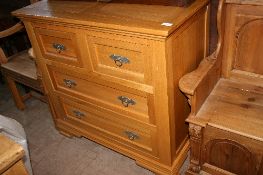 AN OAK HAND CRAFTED CHEST OF DRAWERS HAVING TWO SHORT AND TWO LONG DRAWERS AND BEING ON BRACKET