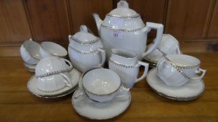 A PART LIMOGES ART DECO STYLE PORCELAIN COFFEE SET COMPRISING TEN CUPS AND TEN SAUCERS, COFFEE