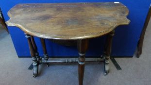 A VICTORIAN OVAL SHAPED  MAHOGANY VENEERED DROP LEAF TABLE ON TURNED COLUMN SUPPORTS UNITED BY A