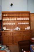 A LARGE PINE KITCHEN DRESSER HAVING OPEN SHELVES TO THE TOP AND THREE DRAWERS AND THREE CUPBOARDS
