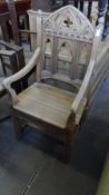 AN ECCLESIASTICAL STYLE PINE CHAIR