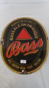 AN OVAL METAL BRASS BREWERY SIGN ADVERTISING BASS ALE ON DRAUGHT, APPROX. 46 X 36 CM