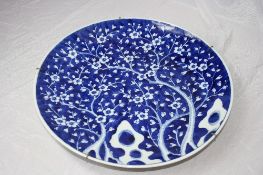 A CIRCA 19TH CENTURY BLUE AND WHITE PORCELAIN CHARGER DEPICTING BLOSSOM TREES, SIDE DECORATION TO