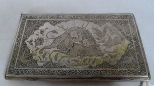 A SOLID SILVER PERSIAN STYLE ANTIQUE CIGARETTE CASE DEPICTING A LION AND ITS PREY IN CENTRAL