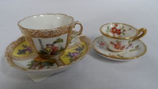 A MINIATURE HAMMERSLEY HAND PAINTED CUP AND SAUCER TOGETHER WITH ONE OTHER MINIATURE CUP AND SAUCER