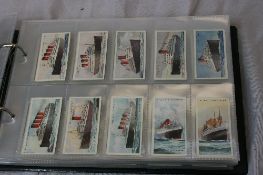 A RING BINDER CONTAINING A COLLECTION OF GALLAHER, PLAYERS AND WILLS CIGARETTE CARDS DEPICTING