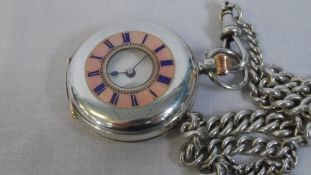 A LADY`S CONTINENTAL SILVER HALF HUNTER POCKET WATCH ON A SOLID SILVER FOB CHAIN - THE WATCH