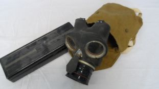 A WORLD WAR II GAS MASK IN CANVAS BAG TOGETHER WITH AN ACCOSON DOMINION MODEL BLOOD PRESSURE