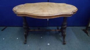 A VICTORIAN MAHOGANY AND WALNUT OCCASIONAL TABLE HAVING CARVED LEGS AND STRETCHERS ON SCROLL FEET,