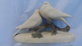 AN EARLY 20th CENTURY SEVRES PORCELAIN GROUP OF A PAIR OF DOVES ON A BRANCH, GLAZED ALL OVER WHITE