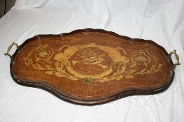 AN ANTIQUE INLAID TEA TRAY DEPICTING HUNTING HORNS, THE SHAPED TRAY HAVING BRASS HANDLES AND A