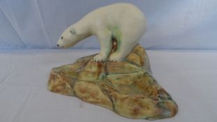 AN UNUSUAL E. RADFORD PIN DISH MODELLED AS A POLAR BEAR ON ROCKS, HAND PAINTED IN NATURAL COLOURS,