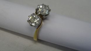 A LADY`S 18ct DIAMOND CROSSOVER RING SET WITH .95 AND 1.10 CT OLD CUT STONES, SIZE O